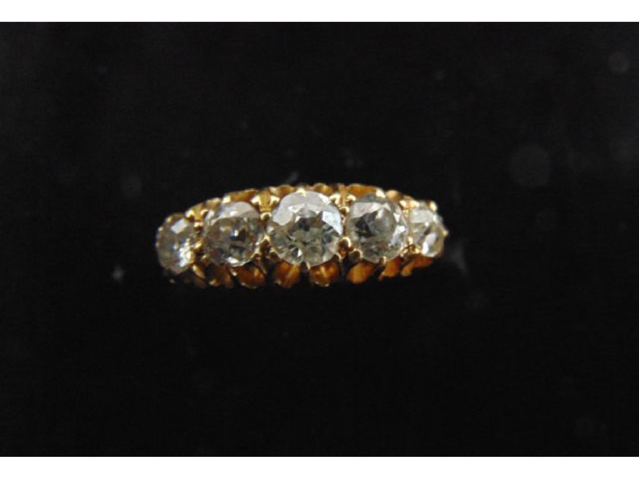 Appraisal: A diamond ring set with five graduated old-cut diamonds weighing