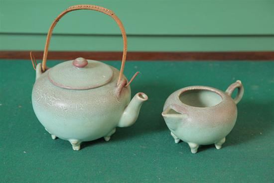 Appraisal: ROOKWOOD TEAPOT AND CREAMER Footed teapot and creamer with green