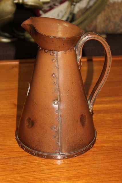 Appraisal: A DOULTON LAMBETH STONEWARE SALT GLAZED JUG with riveted decoration