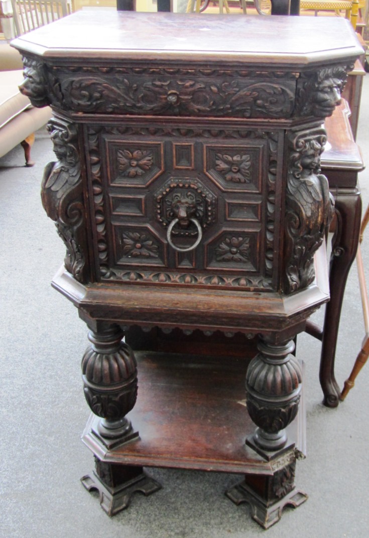 Appraisal: A th century carved oak side cabinet with single drawer