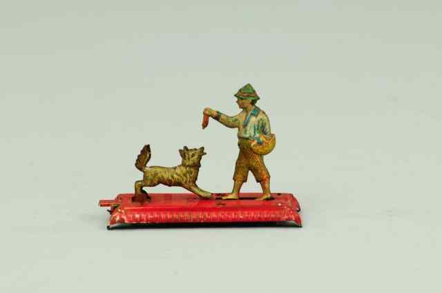 Appraisal: MAN FEEDING DOG PENNY TOY Germany when lever is pushed