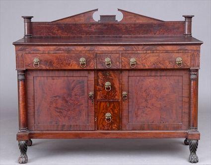 Appraisal: AMERICAN CLASSICAL CARVED MAHOGANY SIDEBOARD The top with breakarch backboard