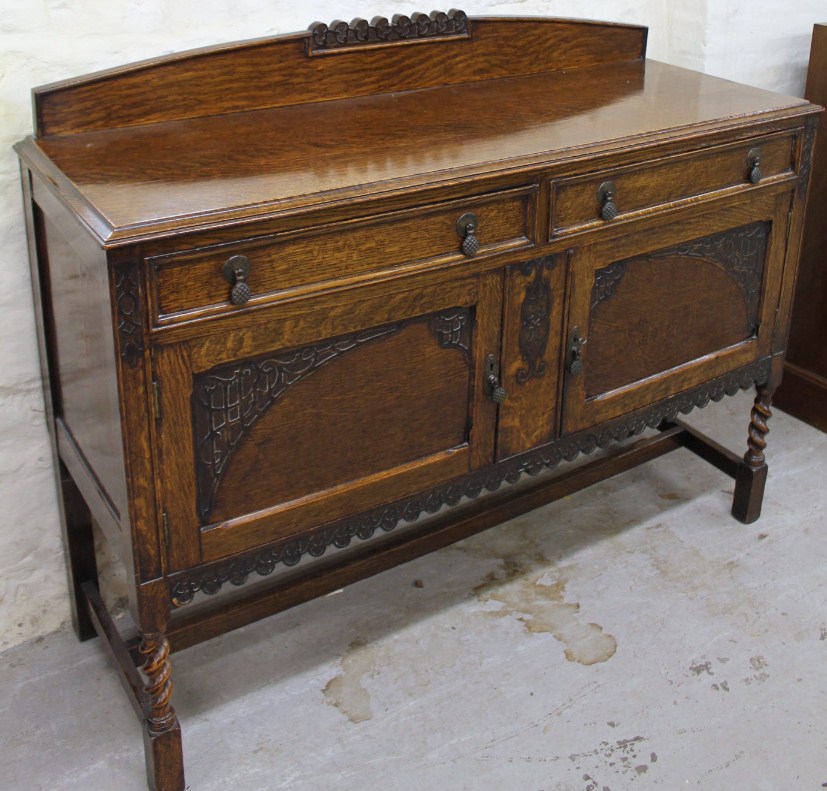 Appraisal: A 's oak sideboard with a curved part carved fixed