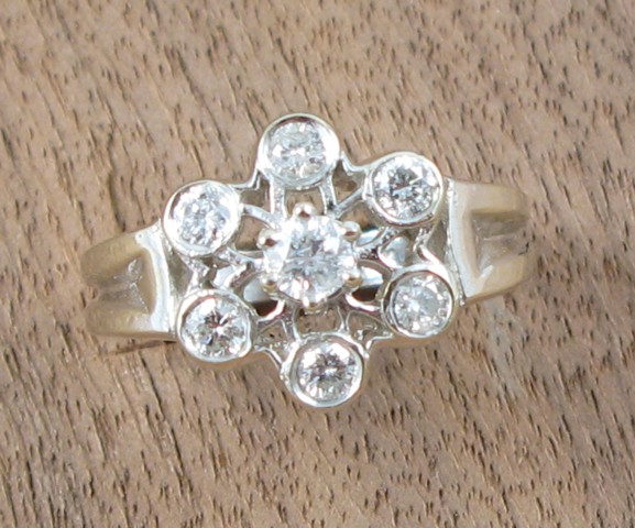 Appraisal: DIAMOND AND FOURTEEN KARAT WHITE GOLD RING set with seven