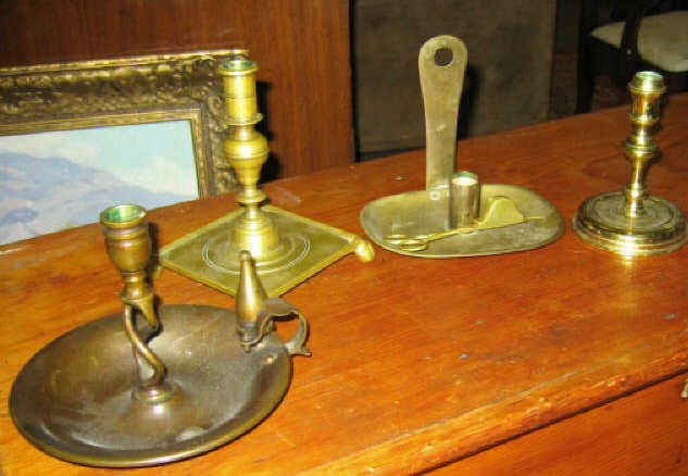 Appraisal: FOUR ASSSORTED BRASS CANDLESTICKS AND SNUFFERS Including a Williamsburg reproduction