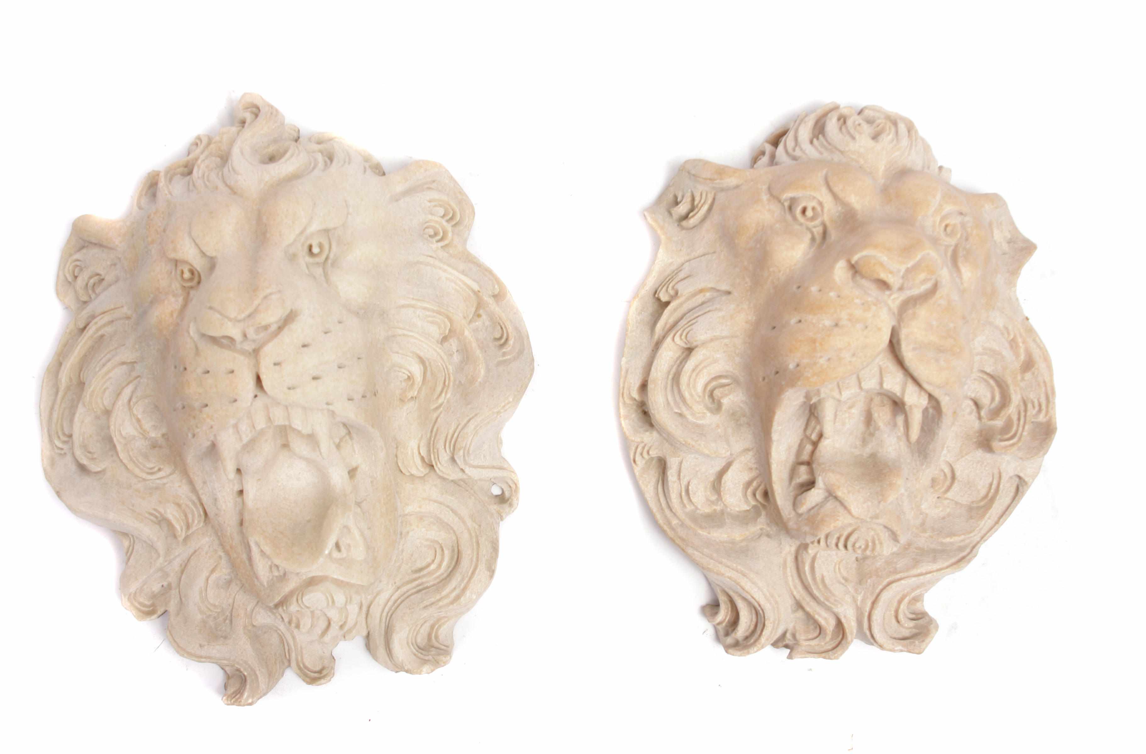 Appraisal: A pair of carved marble lion masks height in width