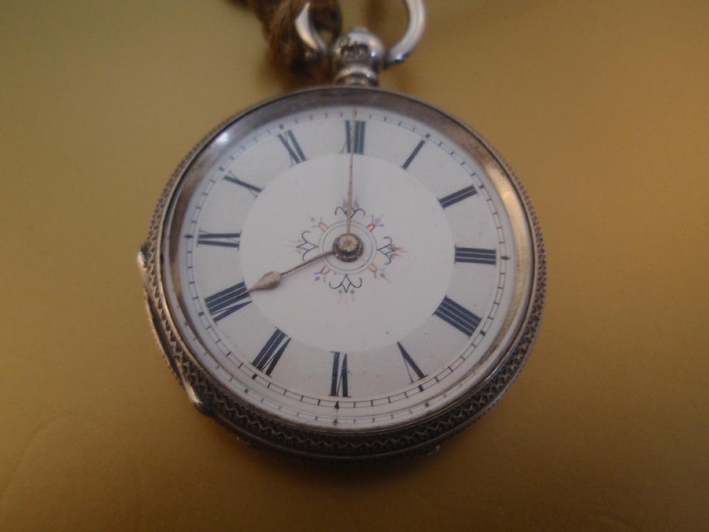 Appraisal: An open faced silver pocket watch and Albert