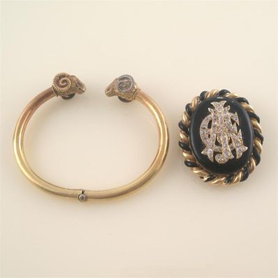 Appraisal: A gold mourning brooch with black enamel decoration and diamond