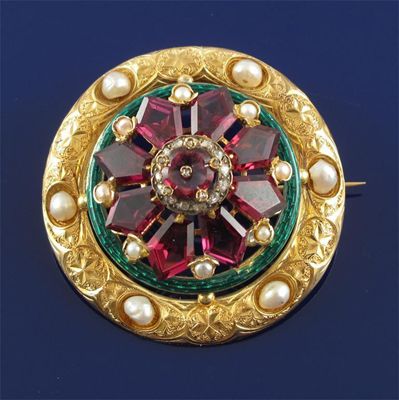 Appraisal: A Victorian circular gold brooch centred with an amethyst and