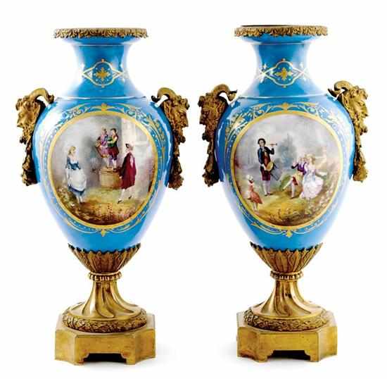 Appraisal: Pair Serves ormolu-mounted porcelain urns circa vasiform painted with vignettes