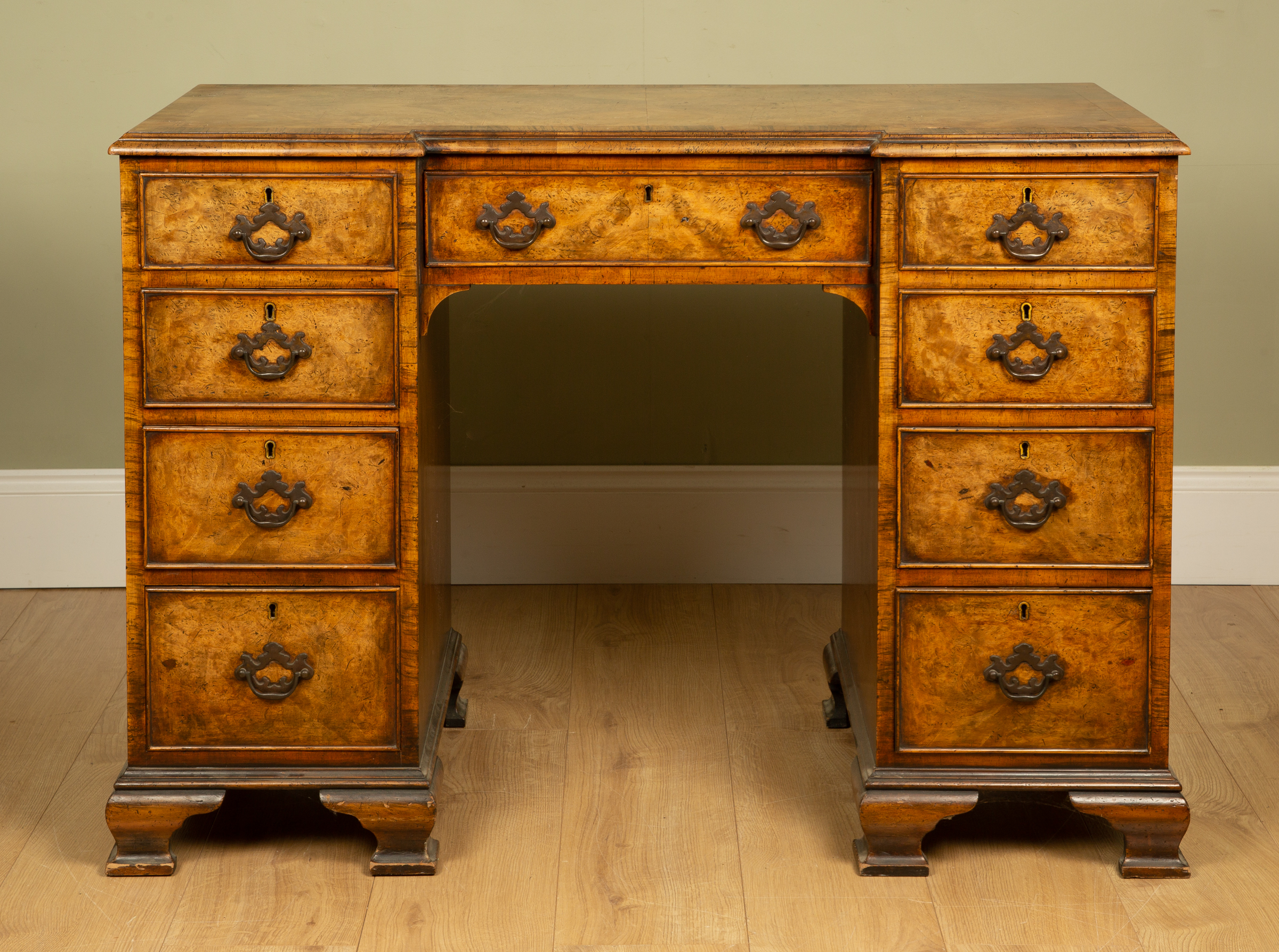 Appraisal: A walnut break front desk with cross banded top and