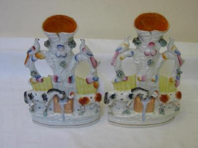 Appraisal: A PAIR OF STAFFORDSHIRE PORCELAIN SPILL VASES modelled as a