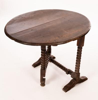 Appraisal: A Charles II oak coaching table with oval tip-up top