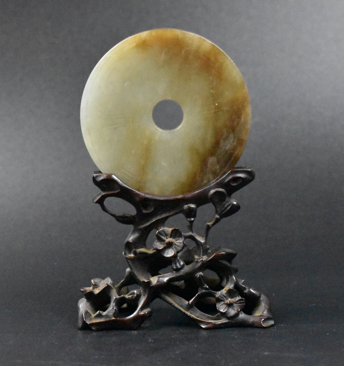 Appraisal: A Chinese jade carved Bi disk and stand dating from