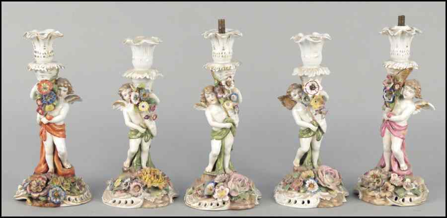 Appraisal: GROUP OF FIVE GERMAN PAINTED AND GILT PORCELAIN CANDLESTICKS Two