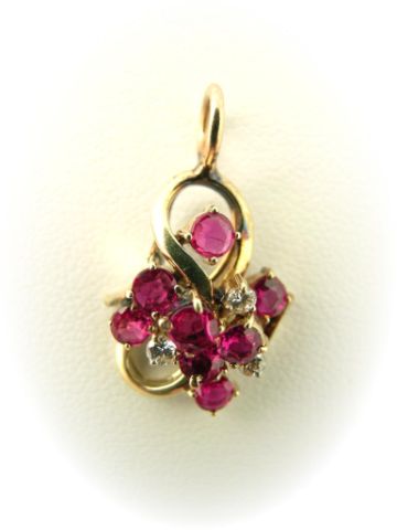 Appraisal: k yellow gold ruby and diamond pendant with eight mm