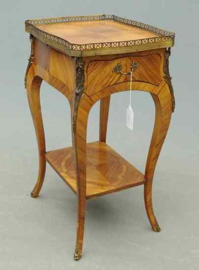 Appraisal: French style mixed wood single drawer stand with brass gallery