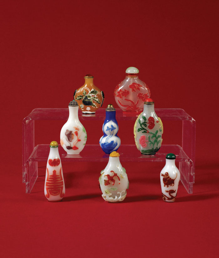 Appraisal: EIGHT CHINESE OVERLAY AND CARVED GLASS SNUFF BOTTLES Variously overlaid