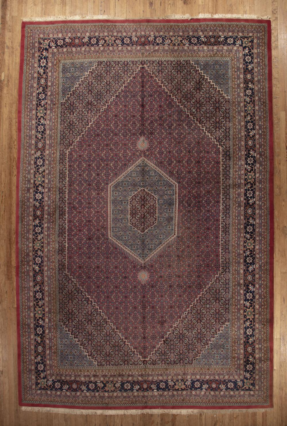 Appraisal: Large Persian Carpet red and blue ground central medallion repeating