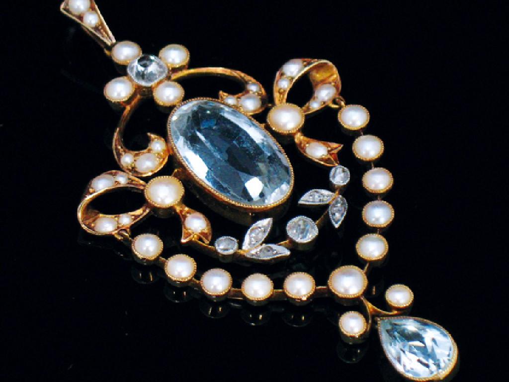 Appraisal: A BLUE TOPAZ AND SEED PEARL EDWARDIAN PENDANT collet-set to