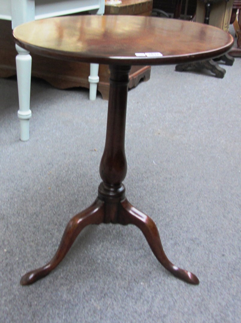 Appraisal: An th century mahogany circular snap top occasional table on