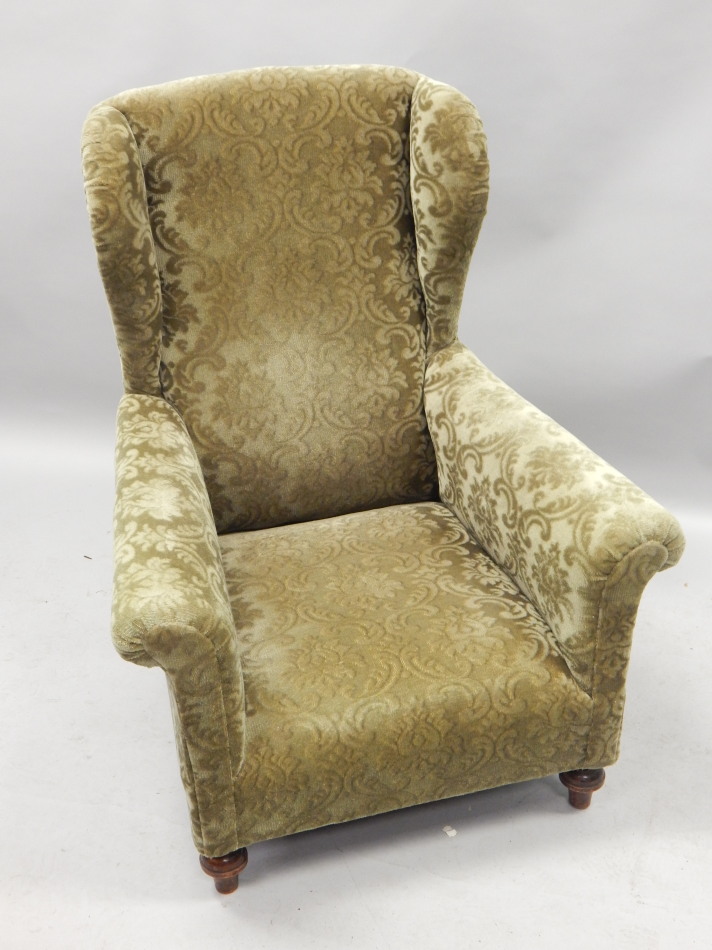 Appraisal: An Edwardian mahogany wingback chair upholstered in green pattern draylon