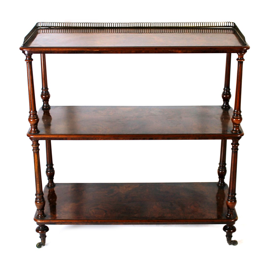 Appraisal: A Victorian figured walnut three tier etagere on turned and