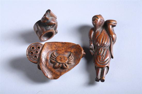 Appraisal: THREE WOOD NETSUKE OF CRAB AND MEN Meiji period Crab