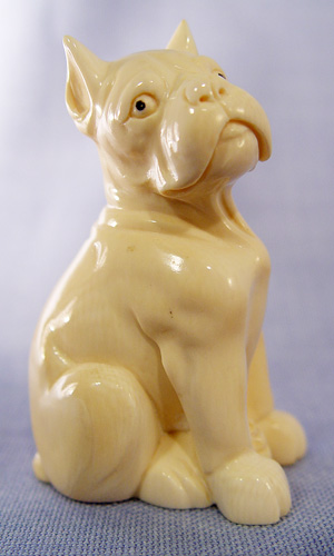 Appraisal: CARVED IVORY MODEL OF A DOG Artist signed on the