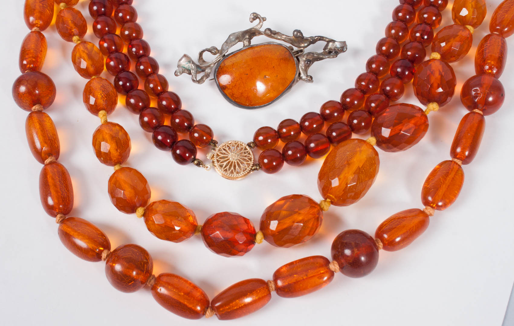 Appraisal: Three amber bead necklaces the longest in L together with