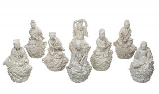 Appraisal: A BLANC-DE-CHINE GROUP OF EIGHT IMMORTALS comprising a deity holding