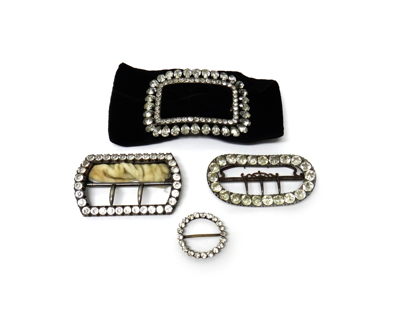 Appraisal: Four colourless paste set jewels comprising a curved oval buckle