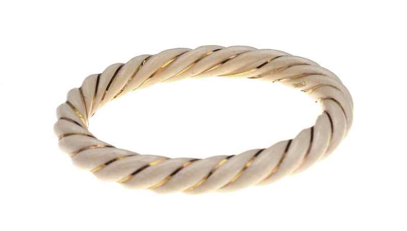 Appraisal: GOLD AND IVORY BANGLE BRACELET Spiral carved ivory bangle bracelet