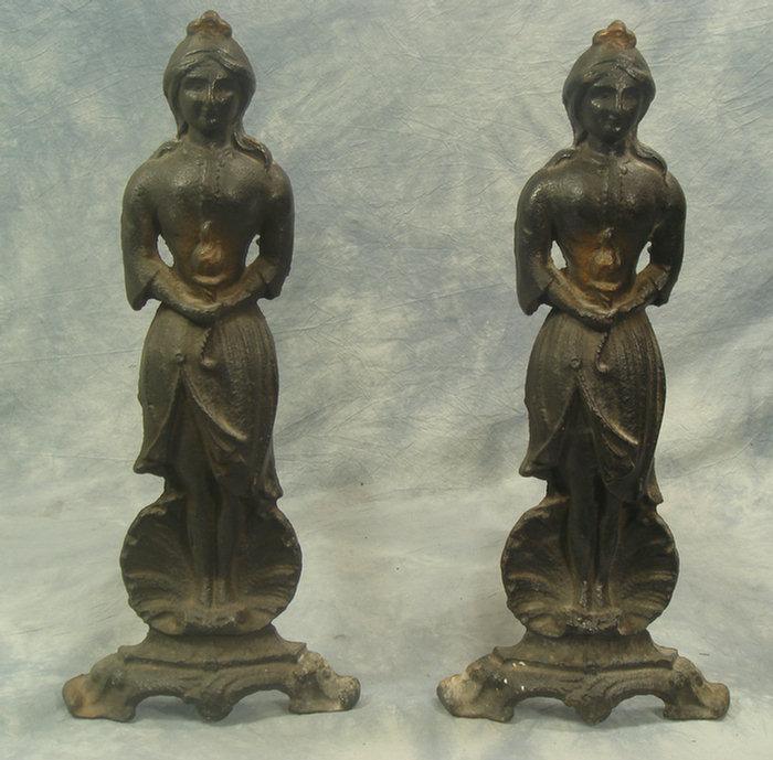 Appraisal: Pr cast iron standing woman on shell andirons h Estimate