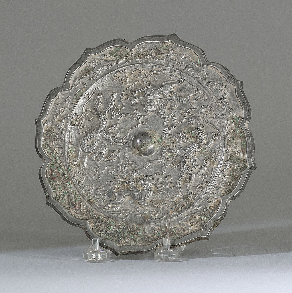 Appraisal: SILVERED-BRONZE MIRROR Tang StyleIn flower form with relief depiction of