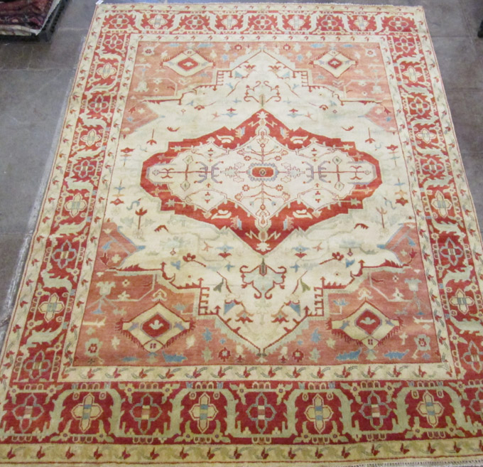 Appraisal: HAND KNOTTED ORIENTAL CARPET stylized floral and central geometric medallion