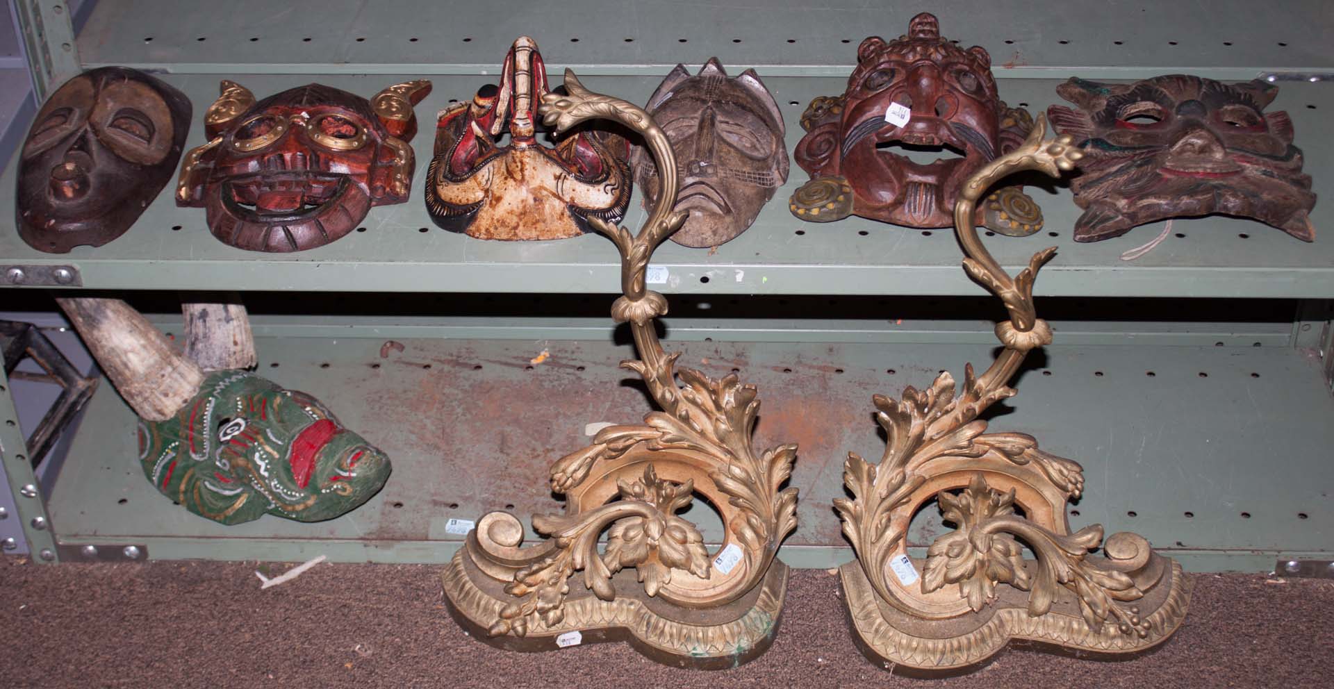 Appraisal: Assorted masks and a pair of brass chenets