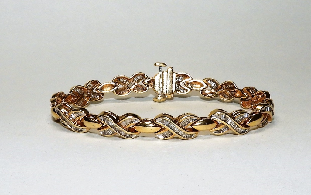 Appraisal: K YELLOW GOLD CT DIAMOND BAGUETTE BRACELET th CenturyCross pattern