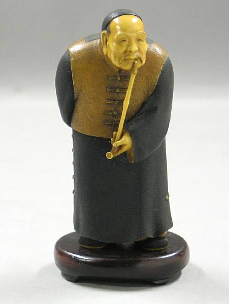 Appraisal: A Japanese tinted ivory figure Depicting a Chinese gentleman smoking