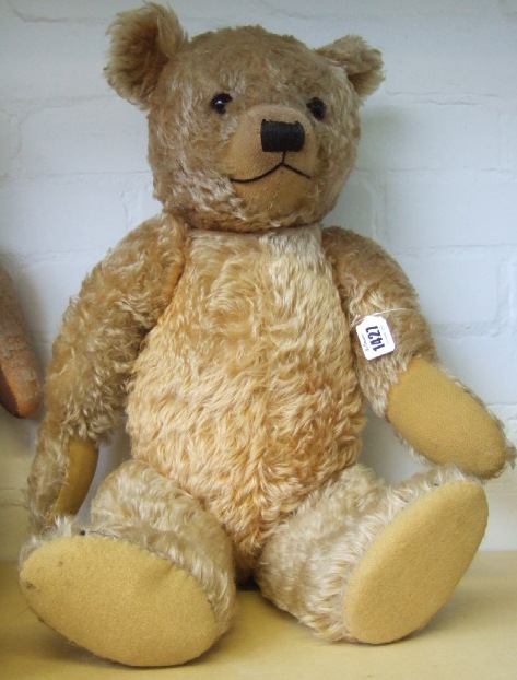 Appraisal: A golden haired teddy bear mid th century with orange