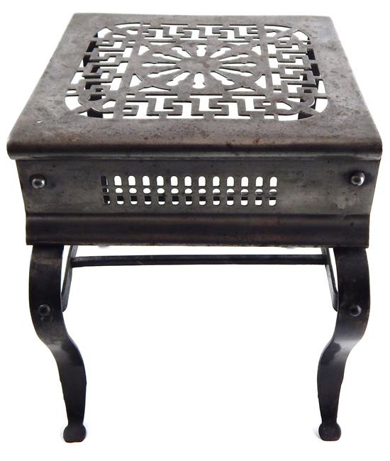 Appraisal: Steel trivet top pierced with geometric design horizontal shelf stretcher