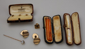 Appraisal: Collection of gentleman's accoutrements including moonstone stick pin amber cigarette