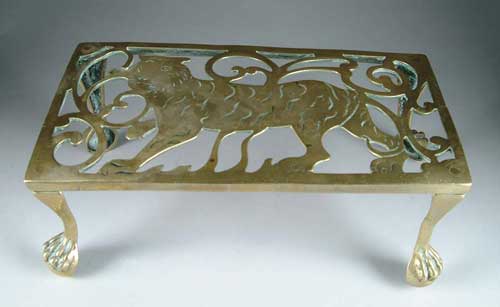 Appraisal: SMALL BRASS FOOT STOOL Lion-decorated flat top with ball and