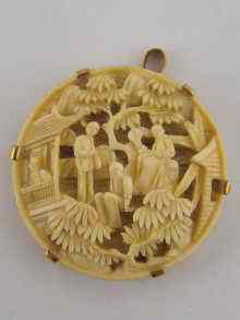 Appraisal: A carved Chinese ivory pendant with yellow metal tests carat