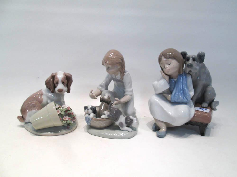 Appraisal: THREE LLADRO PORCELAIN FIGURINES We Can't Play by sculptor Antonio