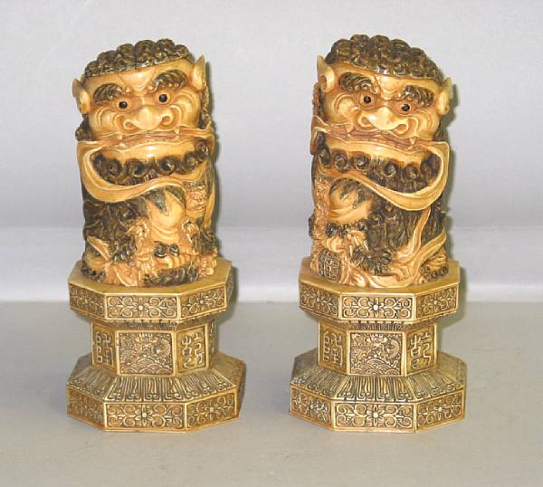 Appraisal: A pair of carved and pieced ivory lions Each on