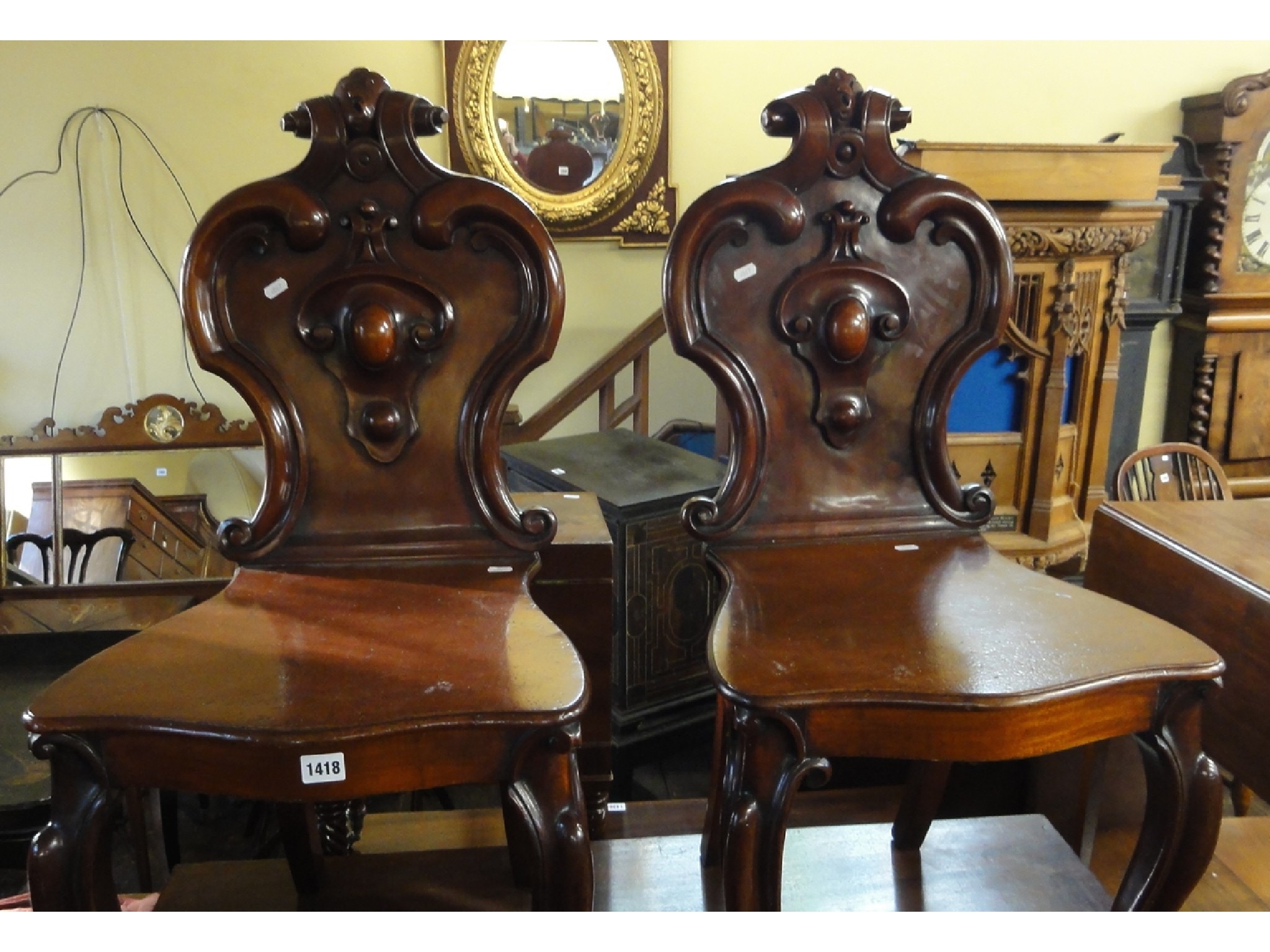 Appraisal: A pair of Victorian mahogany hall chairs with shield shaped