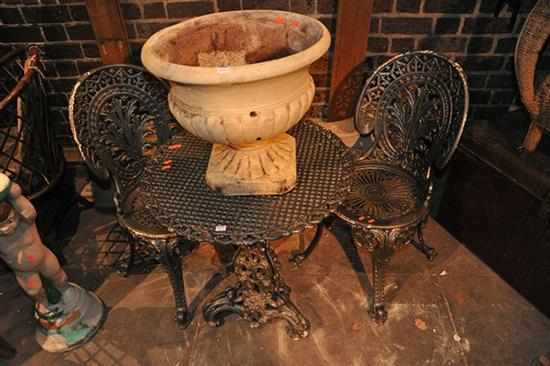 Appraisal: A VICTORIAN STYLE CAST IRON OUTDOOR SETTING OF A TABLE