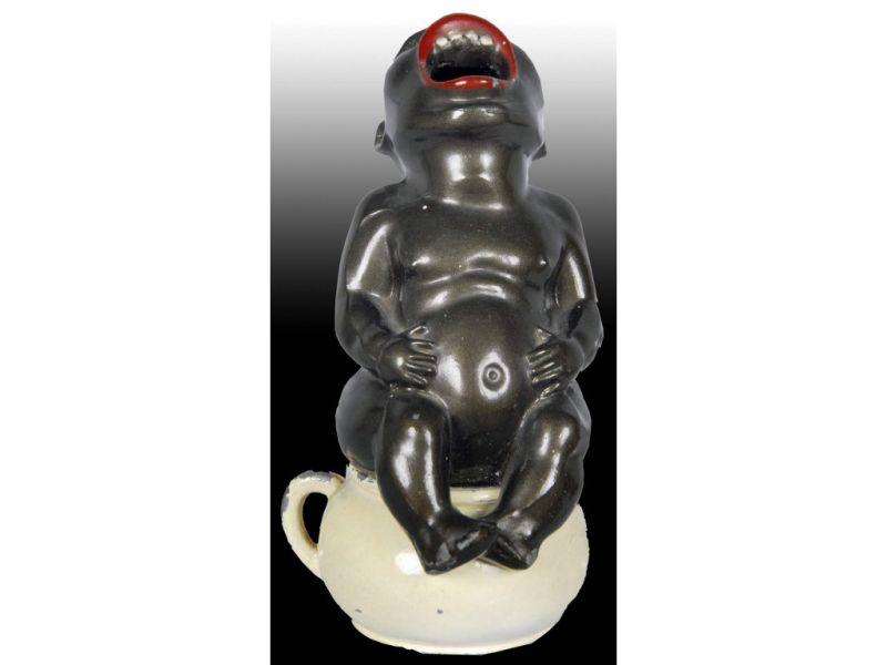 Appraisal: Black Boy on Chamber Pot Metal Incense Burner Description ''