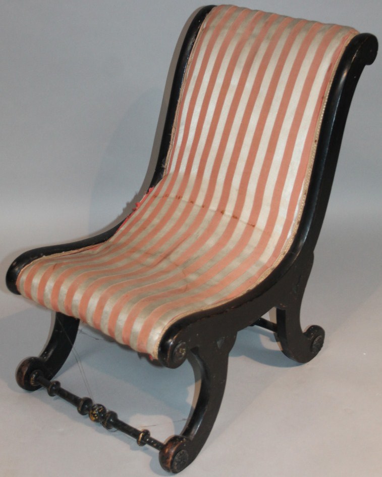 Appraisal: A thC ebonised open chair with scroll outline and overstuffed